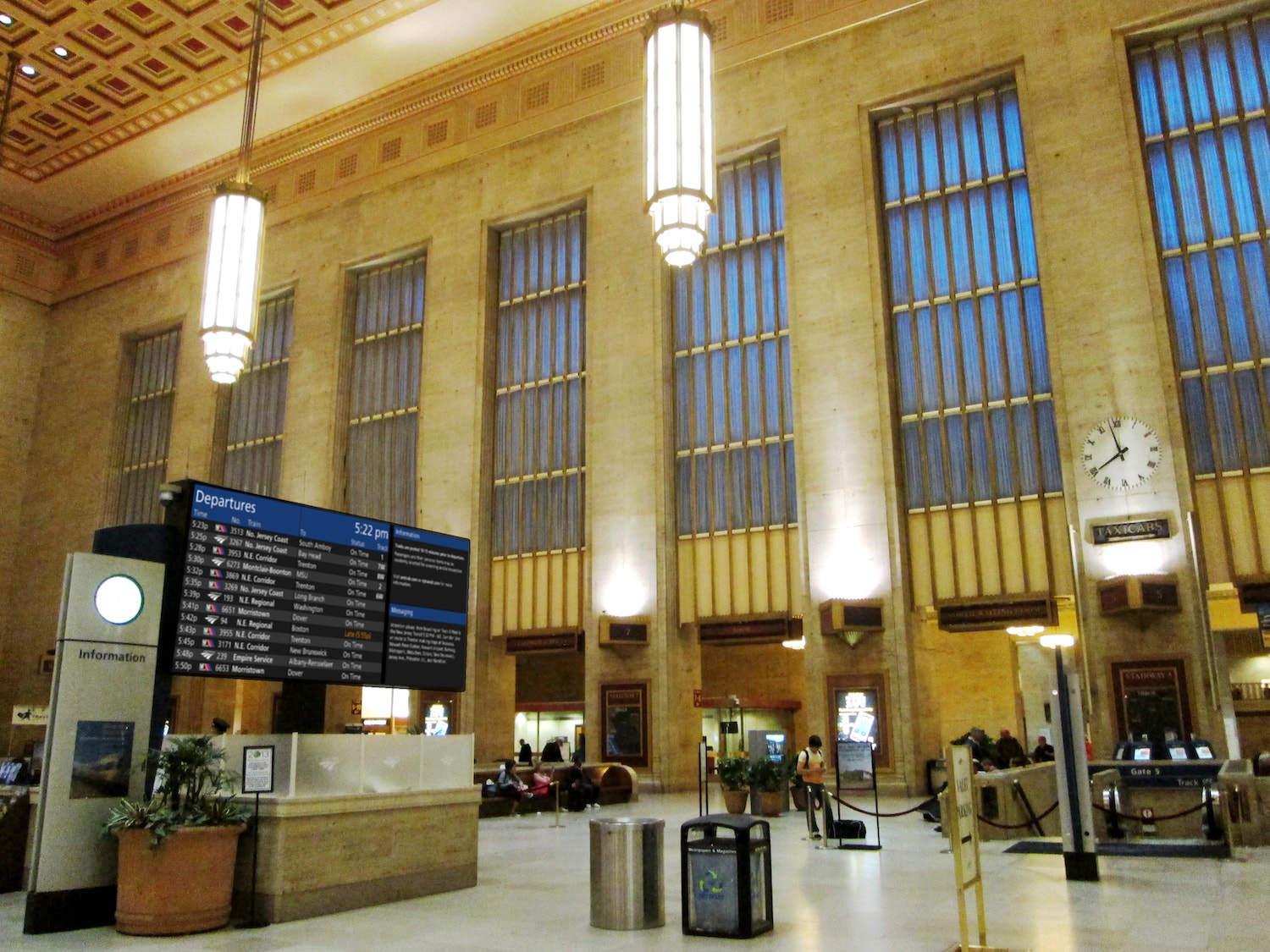 A mockup of 30th Street Station with a digital screen with a darker, more understated design. The sign is modern but does not call attention to itself and fits in more with the character of the building.