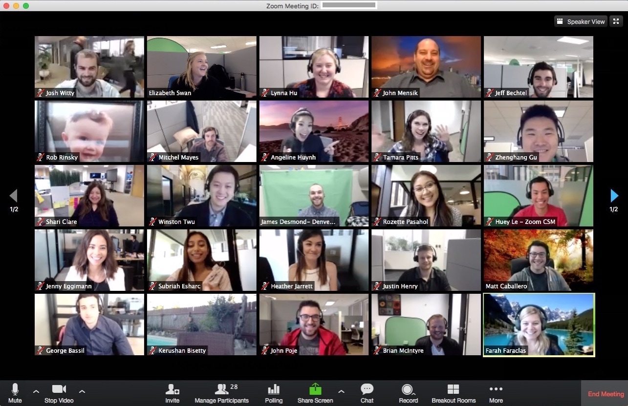 A grid of people's faces on Zoom. Some are waving, most are smiling.